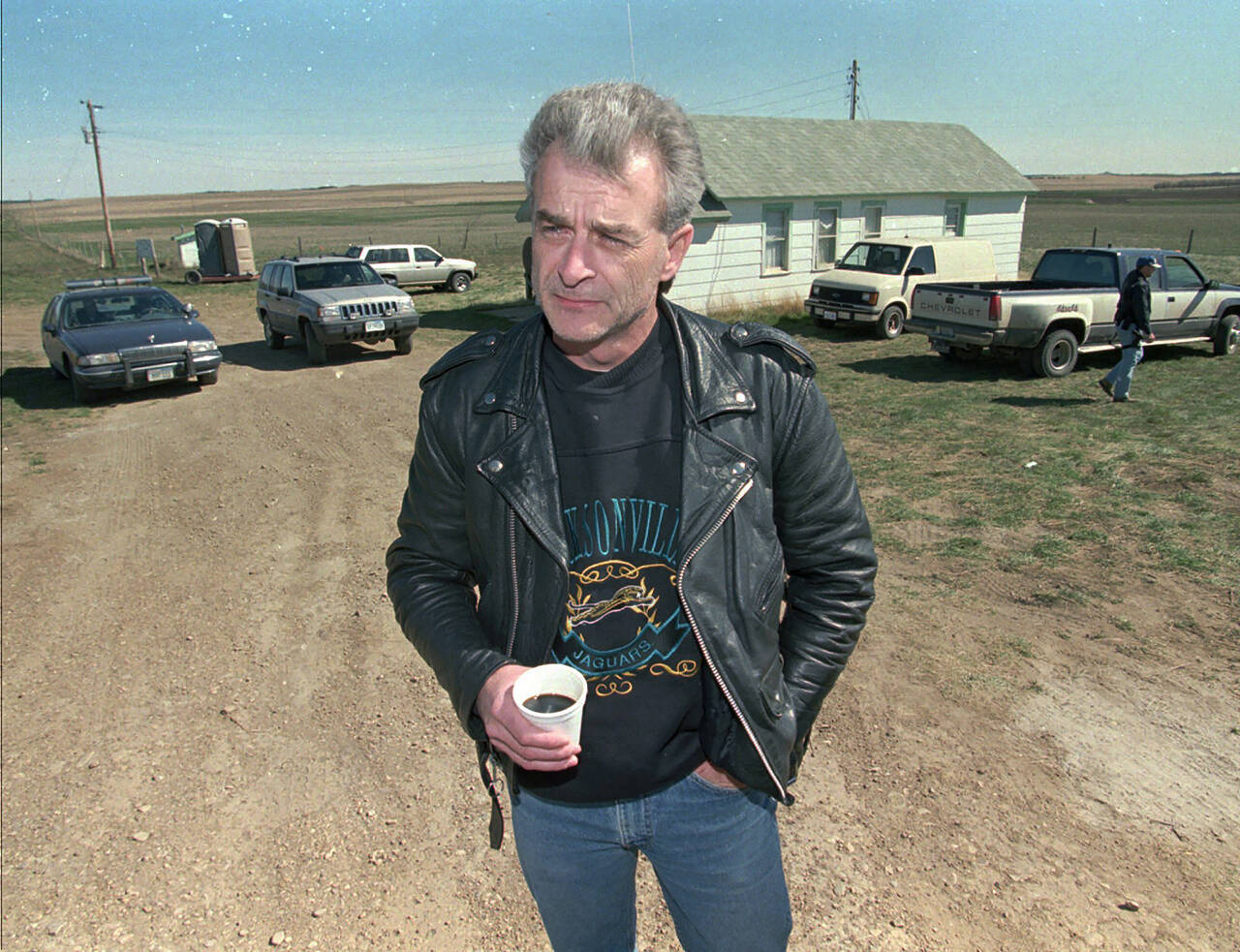 Randy Weaver, the object of the Ruby Ridge siege, visits with the media at the main FBI roadblock outside the Freemen compound in Montana on April 27, 1996. Weaver, patriarch of a family that were involved in an 11-day Idaho standoff in 1992 with federal agents that left three people dead and served as a spark for the growth of anti-government extremists, has died at the age of 74. (AP Photo/Jim Mone, File)