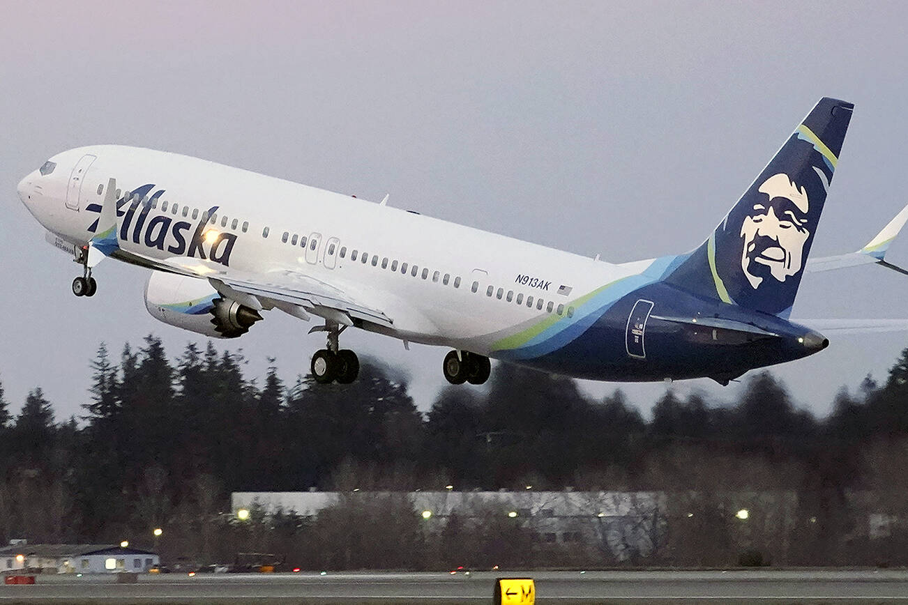 FILE - In this Monday, March 1, 2021 file photo, The first Alaska Airlines passenger flight on a Boeing 737-9 Max airplane takes off on a flight to San Diego from Seattle-Tacoma International Airport in Seattle. A Boeing pilot involved in testing the 737 Max jetliner was indicted Thursday, Oct. 14,2021 by a federal grand jury on charges of deceiving safety regulators who were evaluating the plane, which was later involved in two deadly crashes. (AP Photo/Ted S. Warren, File)