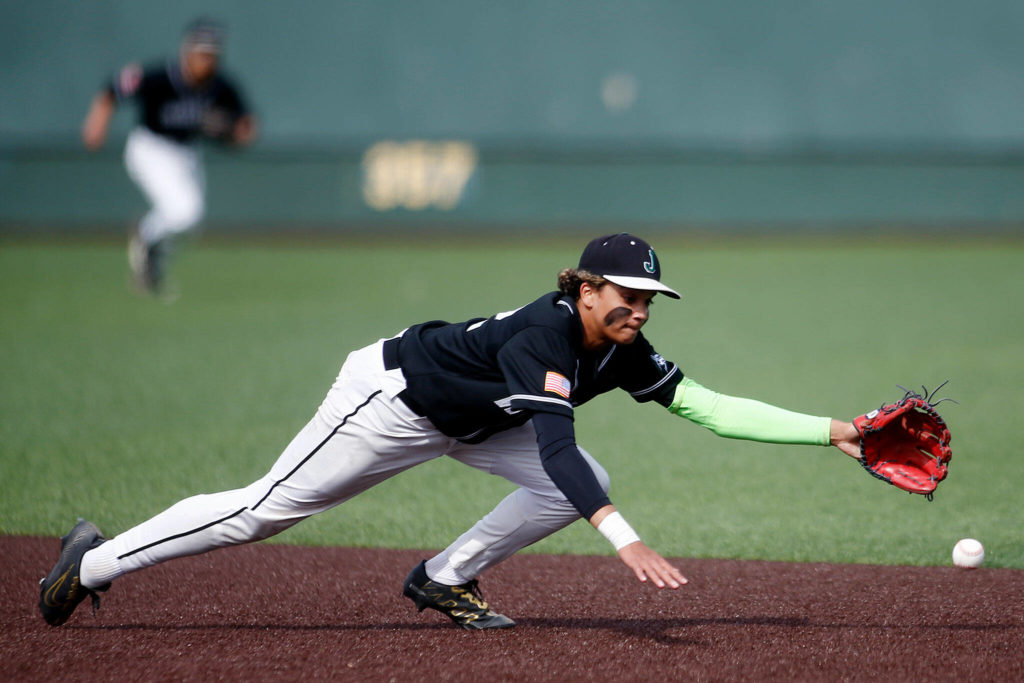 Jackson’s Micah Coleman nearly snags a ground ball at second base against Bothell Friday, May 13, 2022, at Funko Field in Everett, Washington. (Ryan Berry / The Herald)
