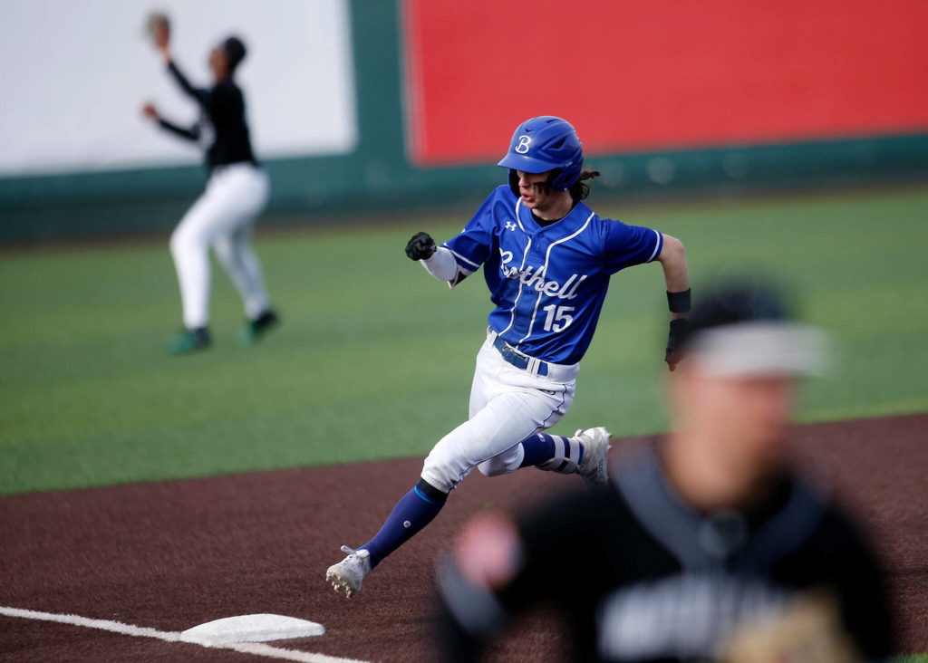 Bothell’s Charlie Meyer rounds third before scoring on a single and error against Jackson Friday, May 13, 2022, at Funko Field in Everett, Washington. (Ryan Berry / The Herald)

