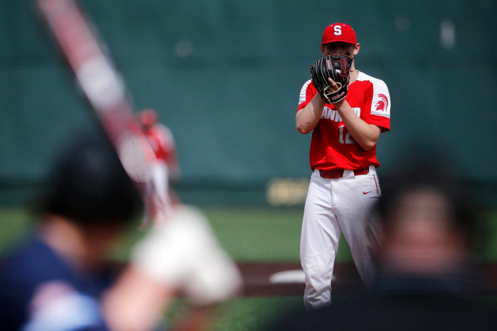 Stanwood’s Mason Goodson looks down to home plate while pitching against Meadowdale Saturday, May 14, 2022, during a 3A district matchup at Funko Field in Everett, Washington. (Ryan Berry / The Herald)
