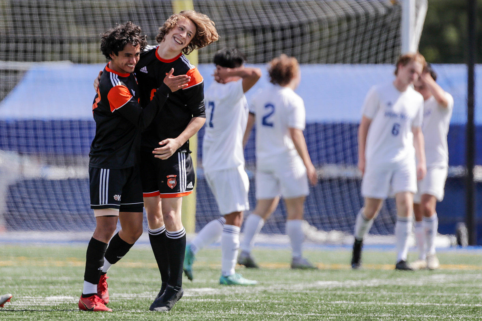 Monroe’s Diego Perez-Diaz, left, and Tanner Summers celebrate their win over Shorewood Saturday afternoon at Shoreline Stadium in Shoreline, Washington on May 14, 2022. The Bearcats won 2-0. (Kevin Clark / The Herald)