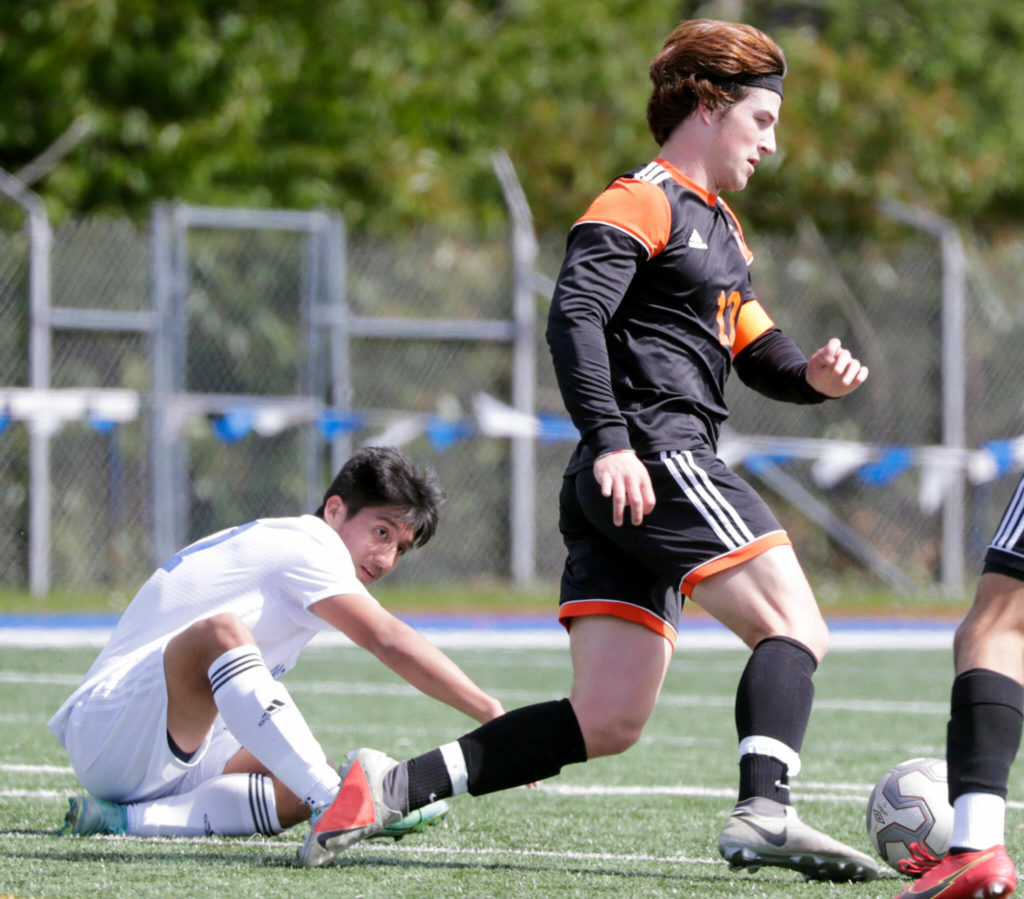 Monroe’s Joshua Gunter controls the ball with Shorewood’s Jadon Lavery, left, looking on Saturday afternoon at Shoreline Stadium in Shoreline, Washington on May 14, 2022. The Bearcats won 2-0. (Kevin Clark / The Herald)
