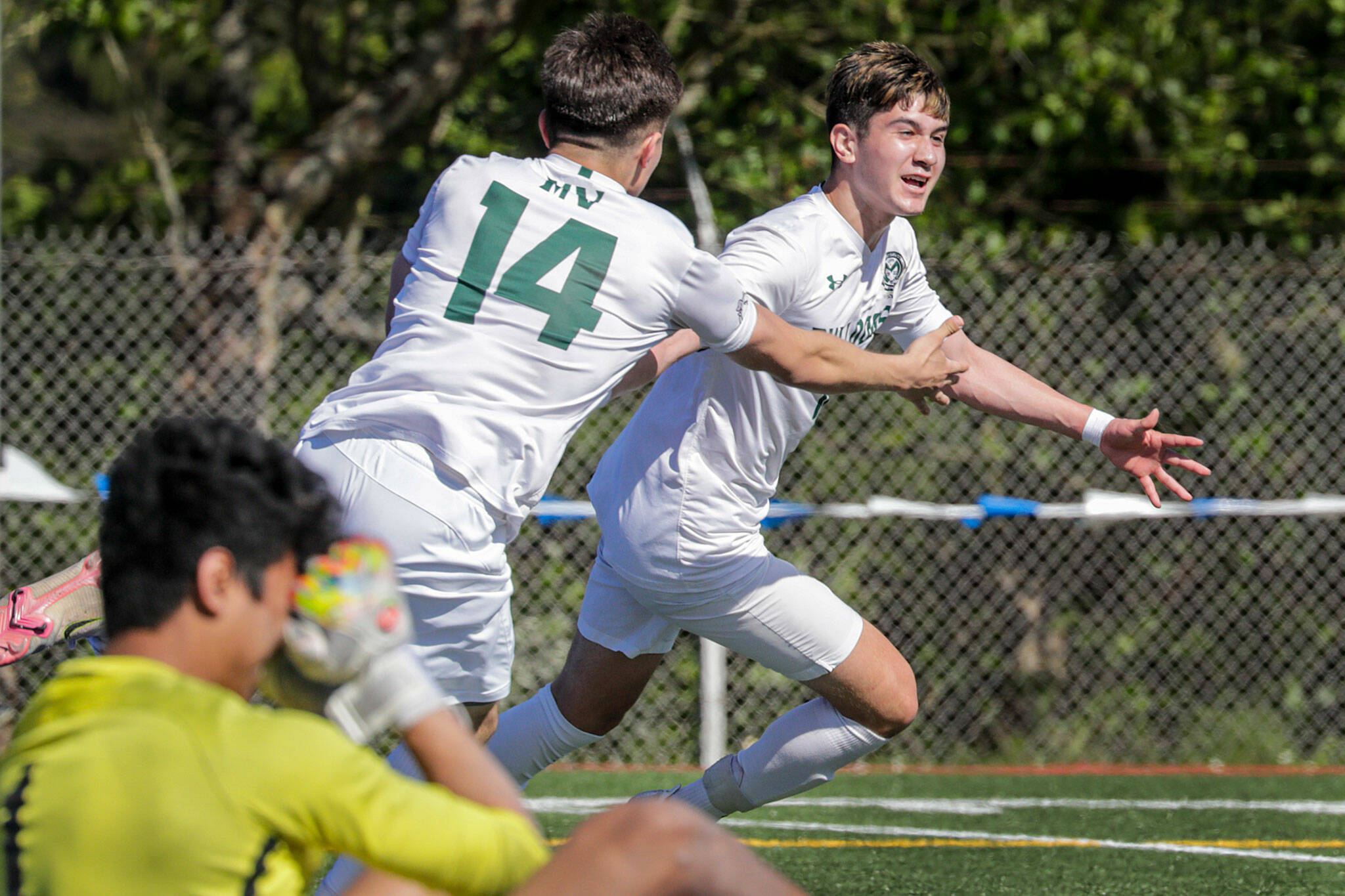 Mount Vernon’s Jonathan Mancillas-Garduno chases teammate Christopher Soto in celebration of a goal against Shorecrest Saturday afternoon at Shoreline Stadium in Shoreline, Washington on May 14, 2022. The Scots lost 2-1 in sudden death. (Kevin Clark / The Herald)