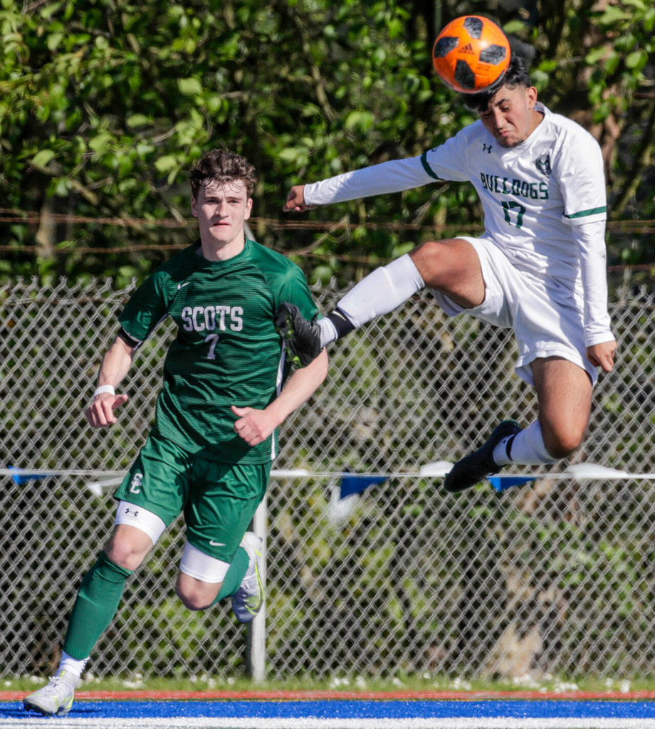 Shorecrest’s Gavin Vanden Berg, left, watches Mount Vernon’s Alexis Herrera-Garduno heads the ball Saturday afternoon at Shoreline Stadium in Shoreline, Washington on May 14, 2022. The Scots lost 2-1 in sudden death. (Kevin Clark / The Herald)
