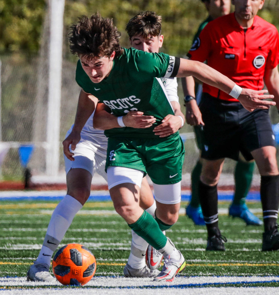 Shorecrest’s Mason Dougherty is pulled and fouled by Mount Vernon’s Christopher Soto Saturday afternoon at Shoreline Stadium in Shoreline, Washington on May 14, 2022. The Scots lost 2-1 in sudden death. (Kevin Clark / The Herald)
