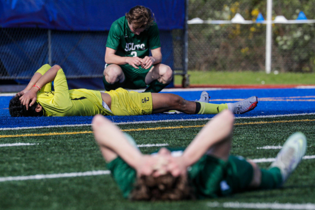 Shorecrest’s team lay dejected after loosing to Mount Vernon Saturday afternoon at Shoreline Stadium in Shoreline, Washington on May 14, 2022. The Scots lost 2-1 in sudden death. (Kevin Clark / The Herald)

