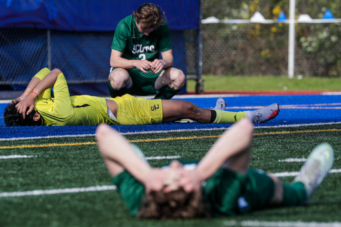 Shorecrest’s team lay dejected after loosing to Mount Vernon Saturday afternoon at Shoreline Stadium in Shoreline, Washington on May 14, 2022.  The Scots lost 2-1 in sudden death. (Kevin Clark / The Herald)