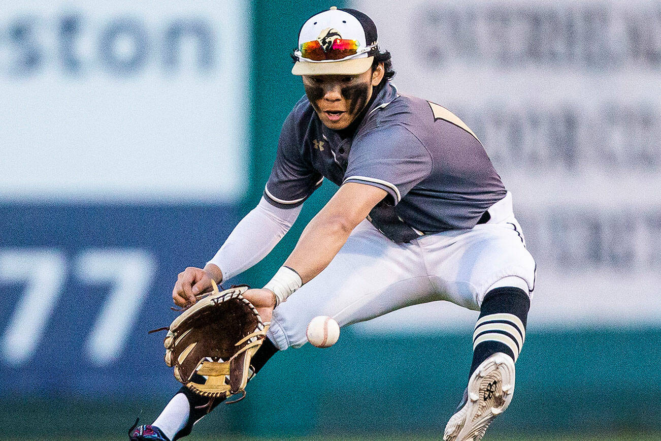 Lynnwood’s Leyon Camantigue stops a ground ball hit past second base during the district semifinal game at Funko Field on Tuesday, May 10, 2022 in Everett, Washington. (Olivia Vanni / The Herald)