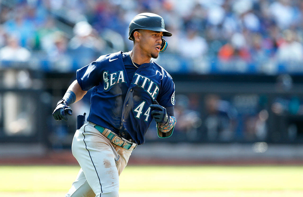 Seattle Mariners’ Julio Rodríguez runs to first base after hitting an RBI single during the seventh inning of a game against the New York Mets on Sunday in New York. (AP Photo/Noah K. Murray)