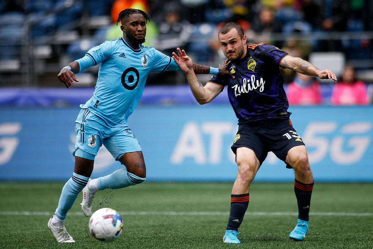 Seattle Sounders’ Jordan Morris crosses the ball while being defended against Minnesota United Sunday, May 15, 2022, at Lumen Field in Seattle, Washington. (Ryan Berry / The Herald)