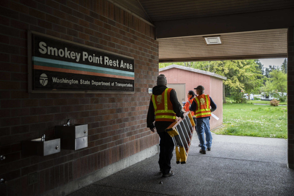 WSDOT workers open up the Smokey Point Rest Area on Tuesday in Arlington. (Olivia Vanni / The Herald)
