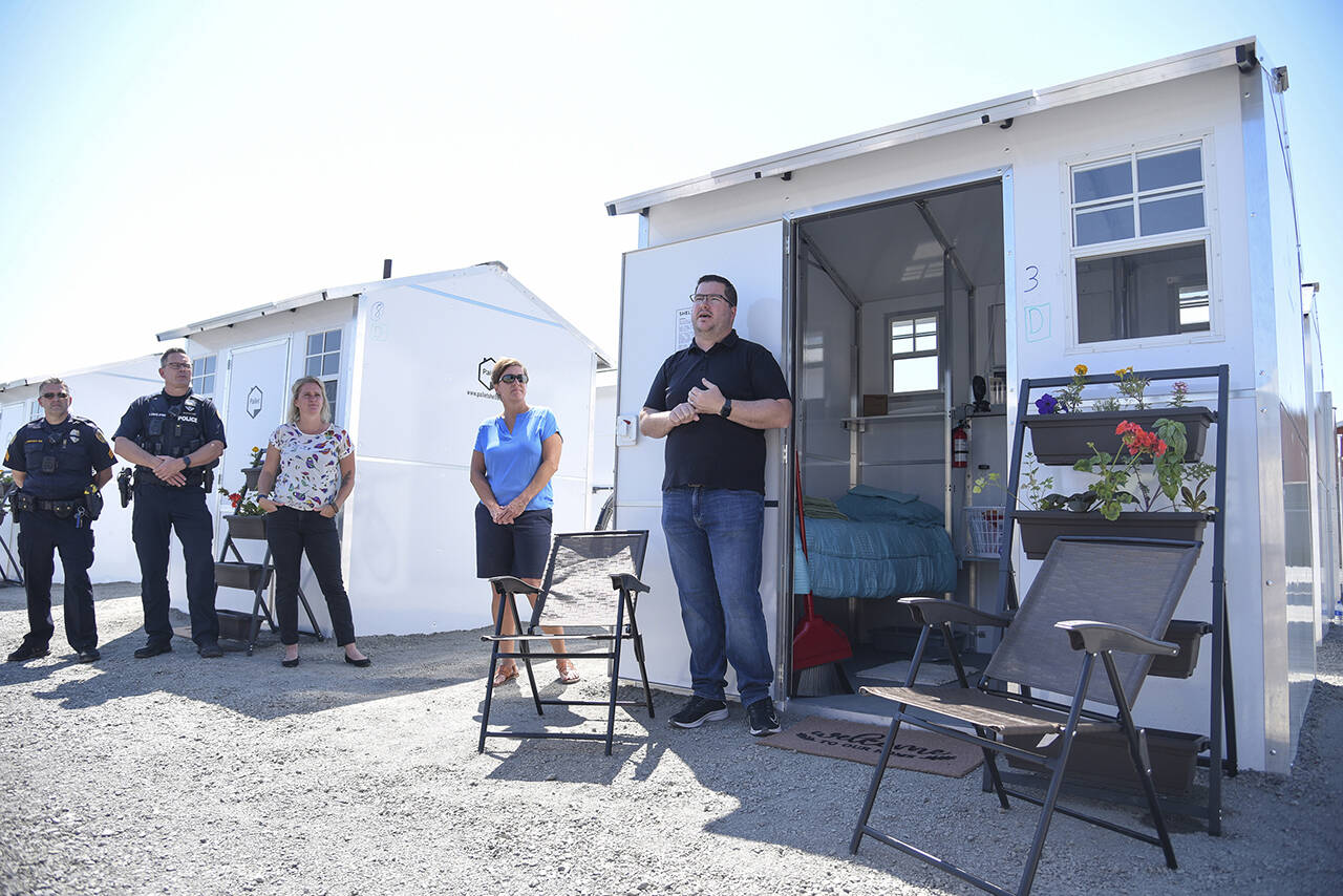 Patrick Diller, head of community partnerships for Pallet, discusses the Pallet Shelter Pilot Project in 2021 in Everett. Last week, the Everett City Council authorized spending $2.7 million for its Pallet Shelter village program. (Katie Hayes / Herald file)