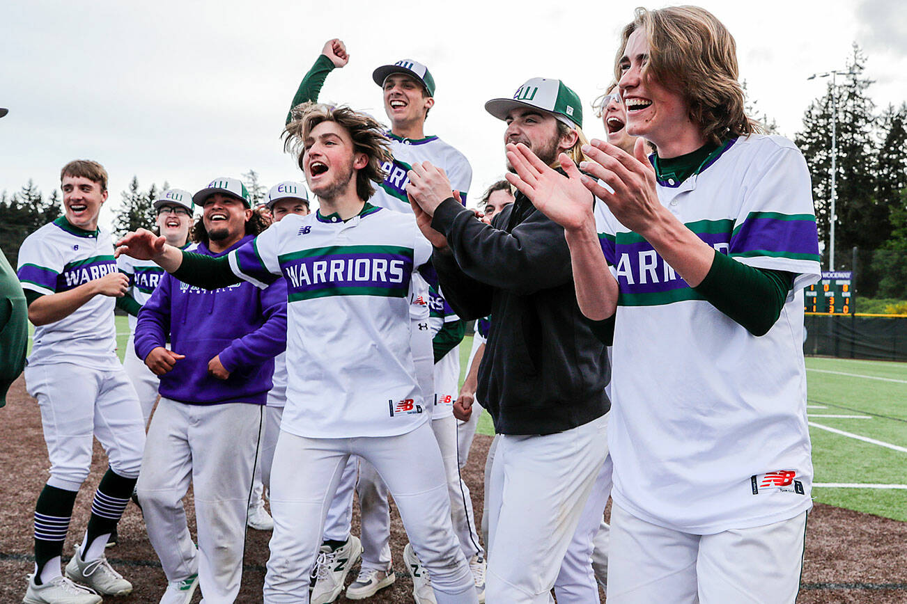 Edmonds-Woodway celebrates their win to advance in the state tournament against Gig Harbor Tuesday afternoon at Edmonds-Wooday High School in Edmonds, Washington on May 17, 2022. The Warriors won 2-1 in 8 innings. (Kevin Clark / The Herald)