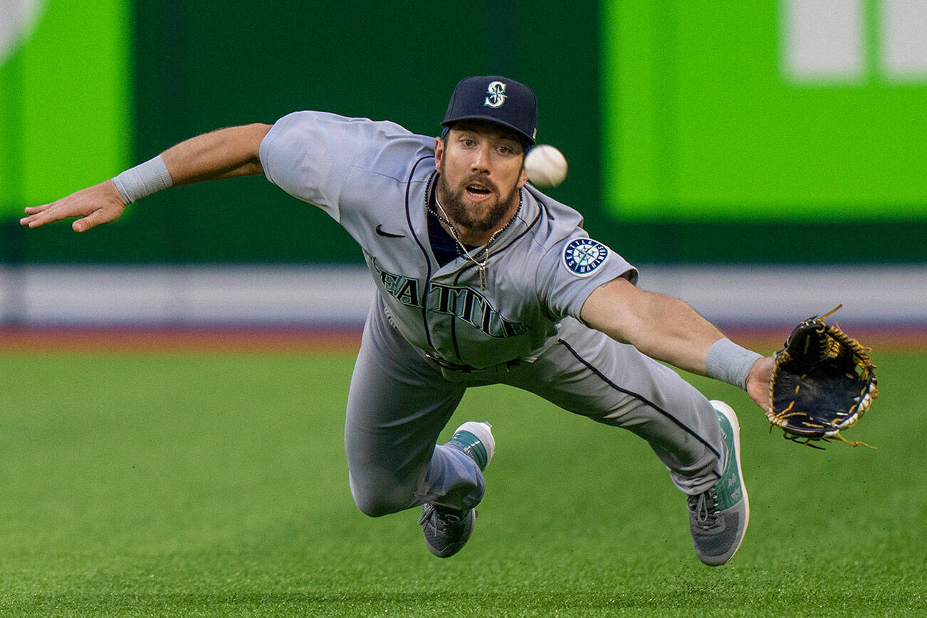 Seattle Mariners right fielder Steven Souza Jr. dives to try to catch a ball hit by Toronto Blue Jays' George Springer for a three-run triple during the second inning of a baseball game Tuesday, May 17, 2022, in Toronto. (Frank Gunn/The Canadian Press via AP)