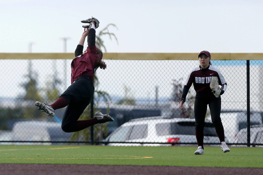 Cascade’s Allison Gehrig makes a leaping catch at second base against Arlington during Tuesday’s Class 3A District 1 matchup at the Phil Johnson Ballfields in Everett. (Ryan Berry / The Herald)
