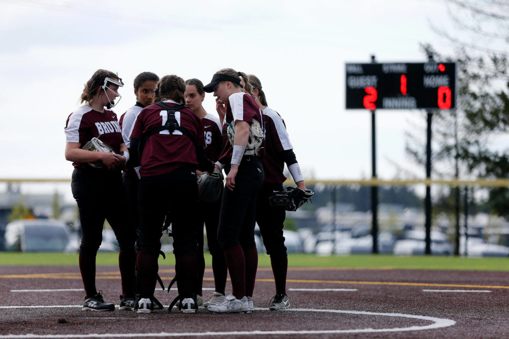 The Cascade infield gets together after surrendering an early lead to Arlington during Tuesday’s Class 3A District 1 matchup at the Phil Johnson Ballfields in Everett. (Ryan Berry / The Herald)
