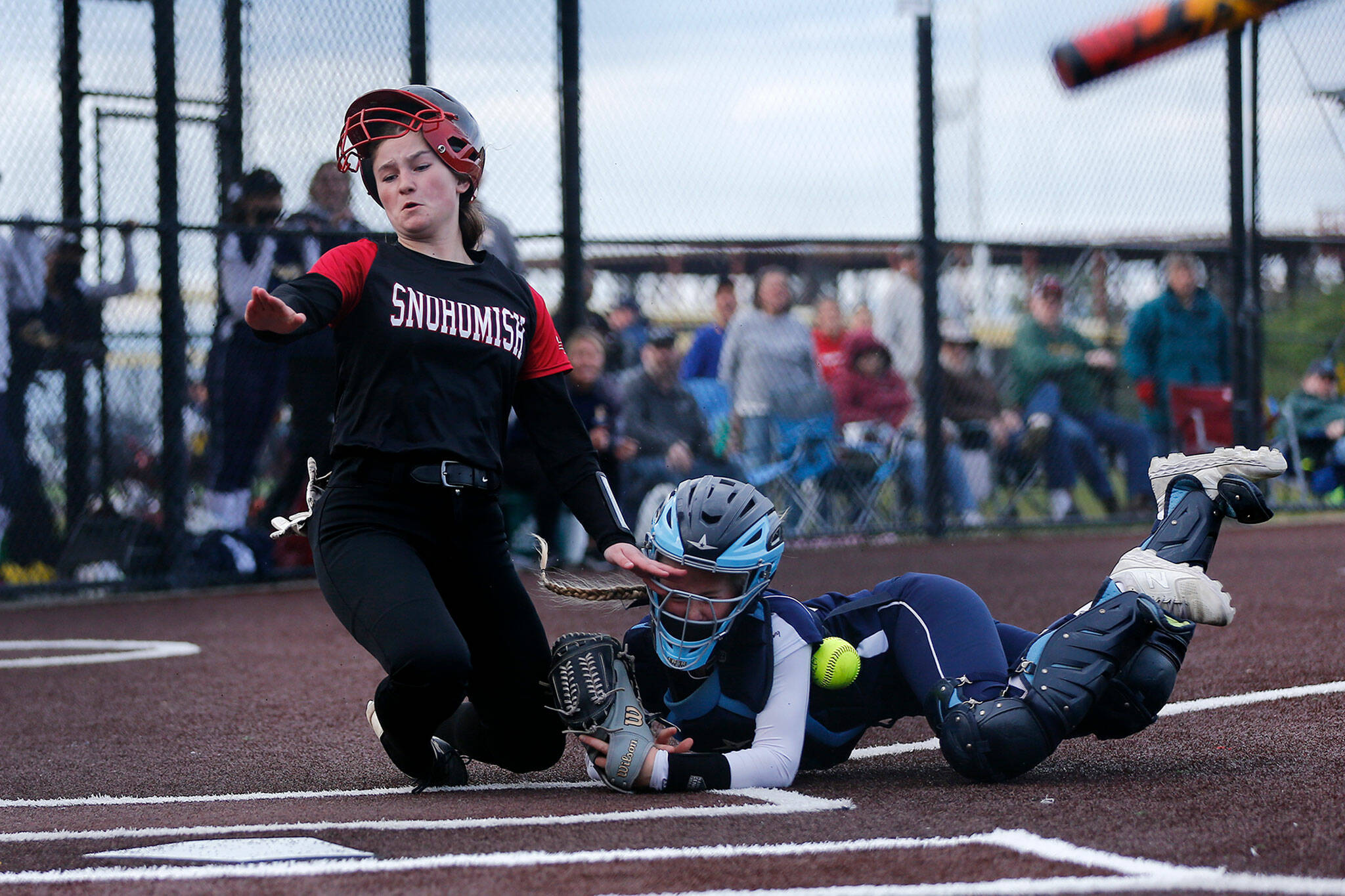 Snohomish’s Brynn VanBrunt collides with Everett catcher Maddie Pewitt before scoring on a sacrifice fly during Tuesday’s Class 3A District 1 matchup at the Phil Johnson Ballfields in Everett. (Ryan Berry / The Herald)