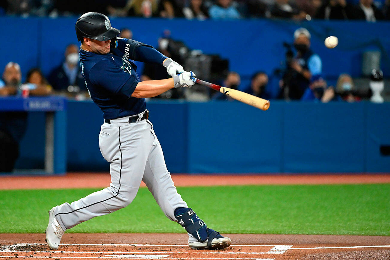 Seattle Mariners' Ty France hits a single during the first inning of a baseball game against the Toronto Blue Jays in Toronto on Wednesday, May 18, 2022. (Jon Blacker/The Canadian Press via AP)