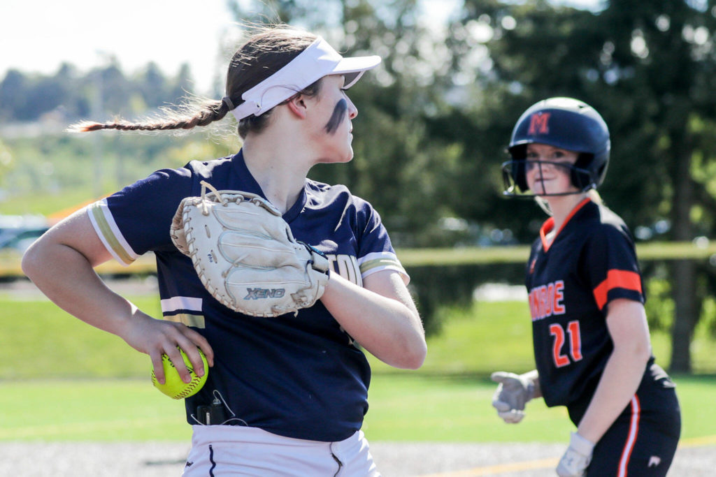 Arlington’s Tayler Stevens looks to Monroe’s Scarlett Nagy after a pop up catch at Phil Johnson Ball Field in Everett, Washington on May 19, 2022.(Kevin Clark / The Herald)
