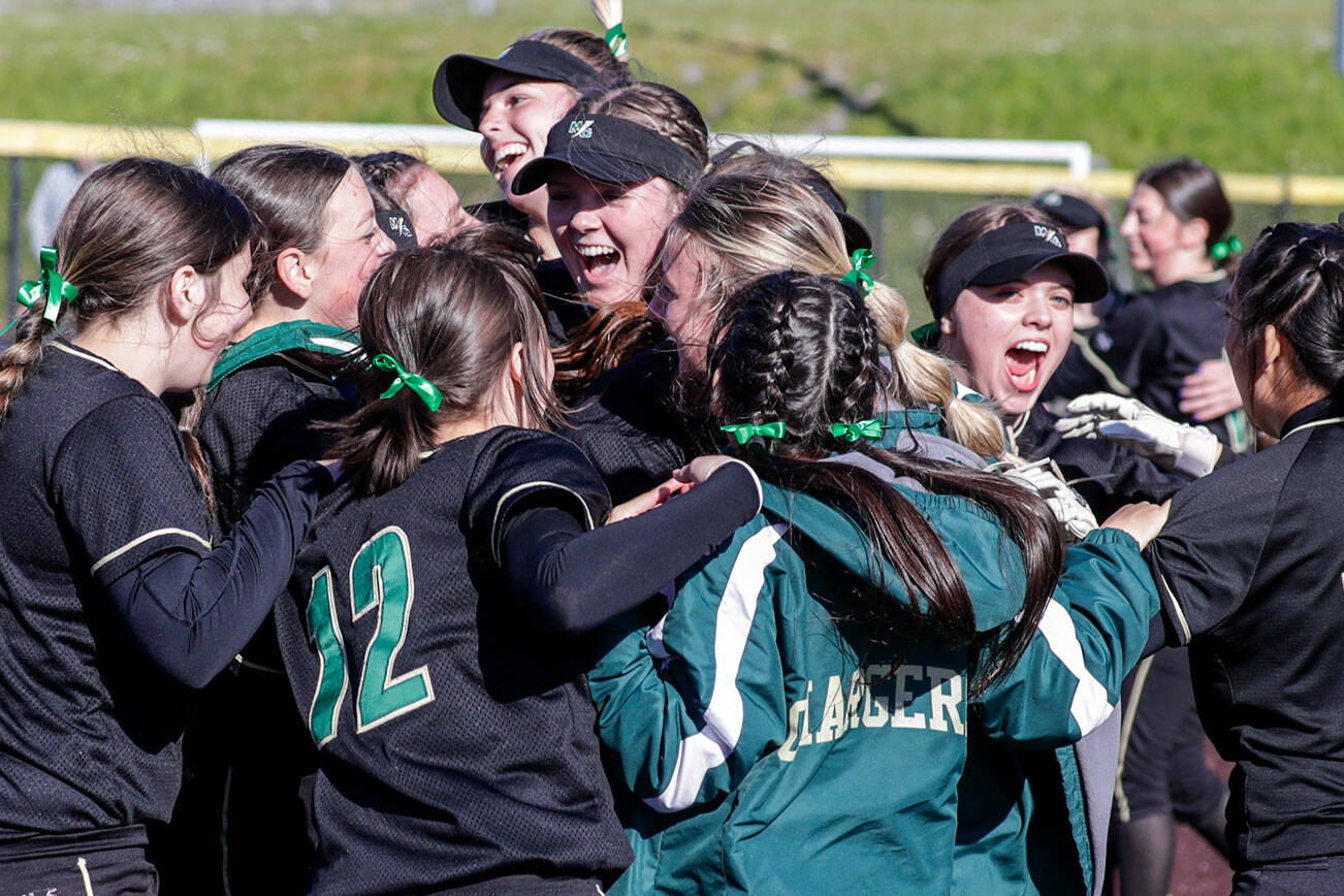 Marysville-Getchell celebrates their 8-1 victory over Everett High School at Phil Johnson Ball Field in Everett, Washington on May 19, 2022.(Kevin Clark / The Herald)