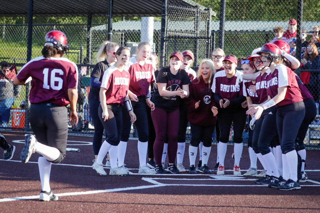 Cascade welcomes Jaidyn Wilson home after her two-run homer against Snohomish Thursday evening at Phil Johnson Ball Field in Everett, Washington on May 19, 2022. The Bruins defeated the Panthers 14-7 to claim the NW District 1 3A Championship title. (Kevin Clark / The Herald)

