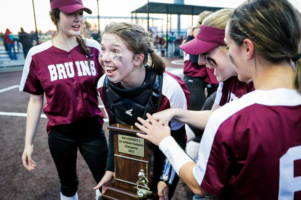 Cascade senior Katelyn Pryor holds the district championship trophy, which marks the latest achievement in her team’s milestone-filled season. (Kevin Clark / The Herald)
