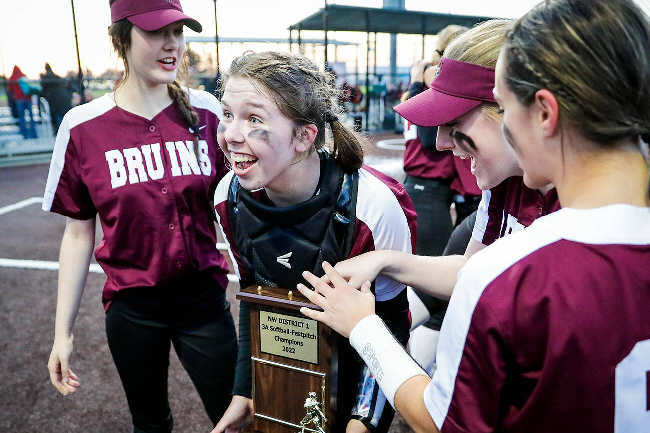 Cascade's Katelyn Pryor holds the championship trophy Thursday evening at Phil Johnson Ball Field in Everett, Washington on May 19, 2022. The Bruins defeated the Panthers 14-7 to claim the NW District 1 3A Championship title. (Kevin Clark / The Herald)