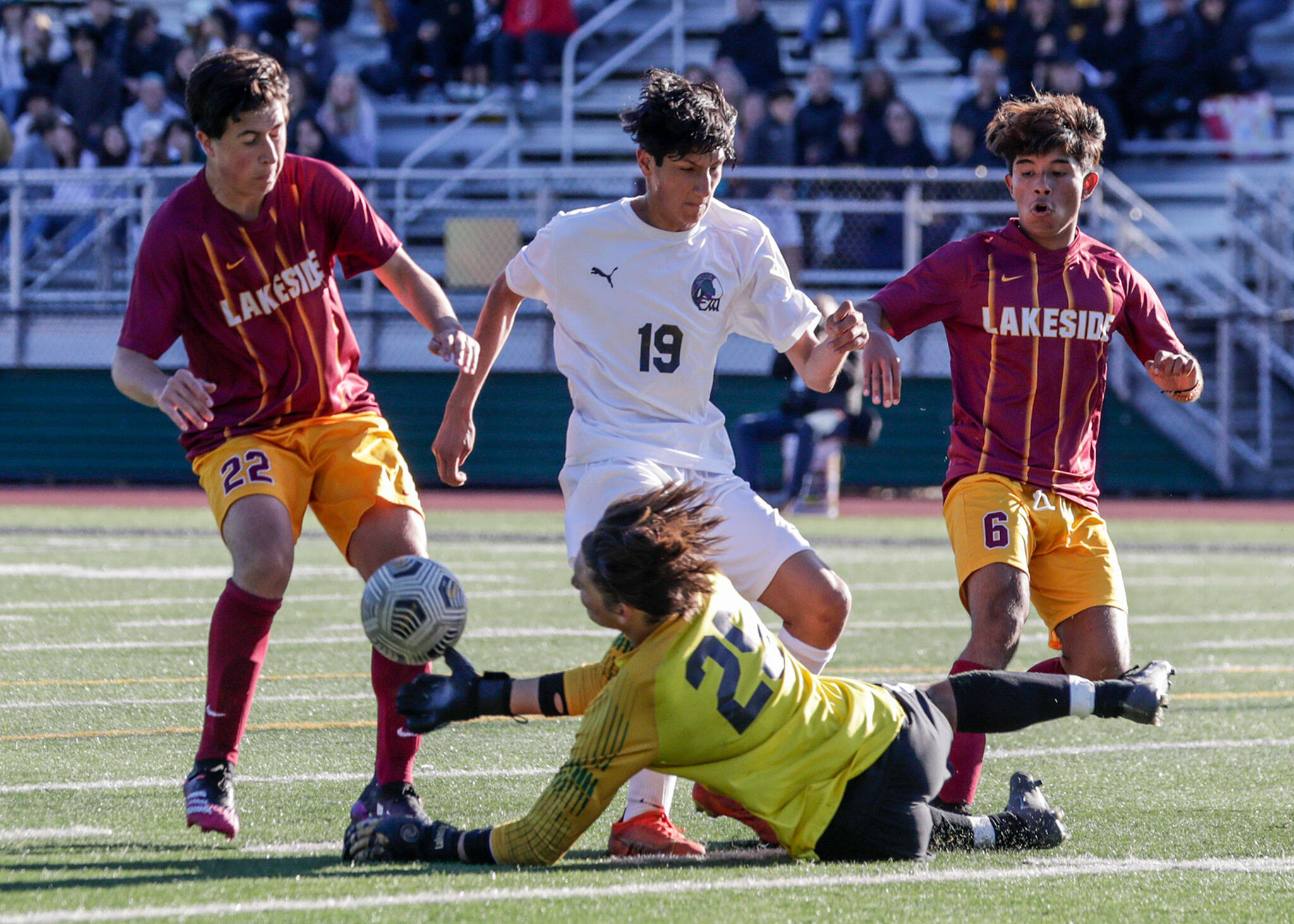 Lakeside’s Thiago Ausland stops a shot at goal with Edmonds-Woodway’s Isaac Parreno charging during a Class 3A state tournament game Friday in Seattle. The Warriors lost 4-0. (Kevin Clark / The Herald)