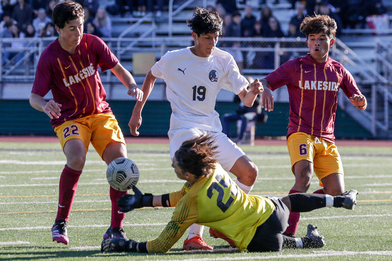 Lakeside’s Thiago Ausland stops a shot at goal with Edmonds-Woodway's Isaac Parreno charging with Lakeside’s Joshua Koch, left, and Uriel Lopez Friday afternoon in Seattle, Washington on May 20, 2022. The Warriors lost 4-0. (Kevin Clark / The Herald)