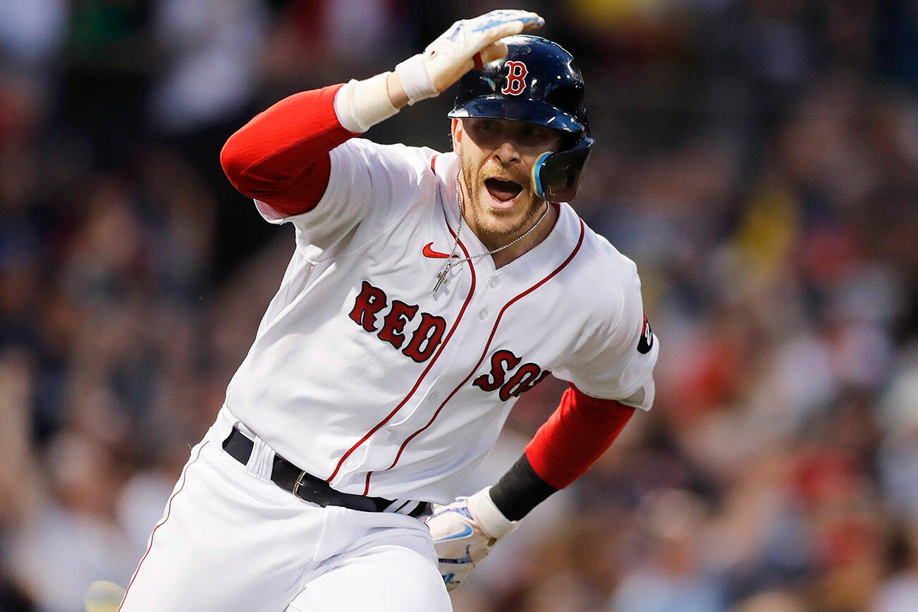 Boston Red Sox's Trevor Story looks to the dugout after hitting a grand slam against the Seattle Mariners during the third inning of a baseball game Friday, May 20, 2022, in Boston. (AP Photo/Michael Dwyer)
