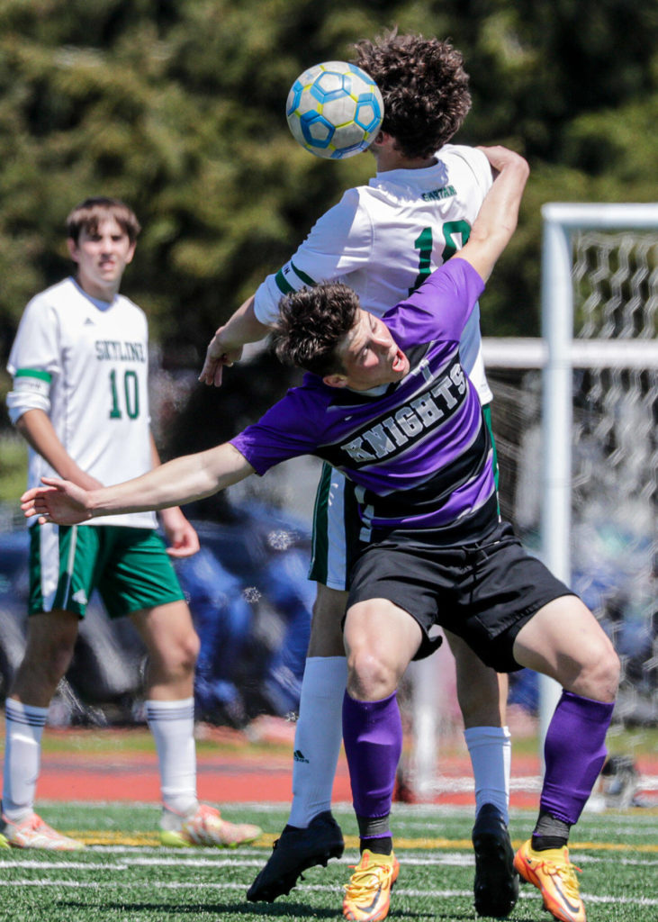 Kamiak’s Koll Pehlivanian and Skyline’s Charles Gall jump for a header during a Class 4A state quarterfinal game Saturday afternoon at Goddard Stadium in Everett. The Knights lost 5-2. (Kevin Clark / The Herald)
