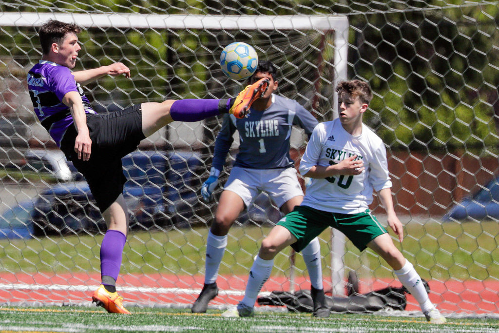 Kamiak’s Koll Pehlivanian scores a goal over Skyline’s Arnav Murudkar and Colin McKenna, right, during a Class 4A state quarterfinal game Saturday afternoon at Goddard Stadium in Everett. The Knights lost 5-2. (Kevin Clark / The Herald)
