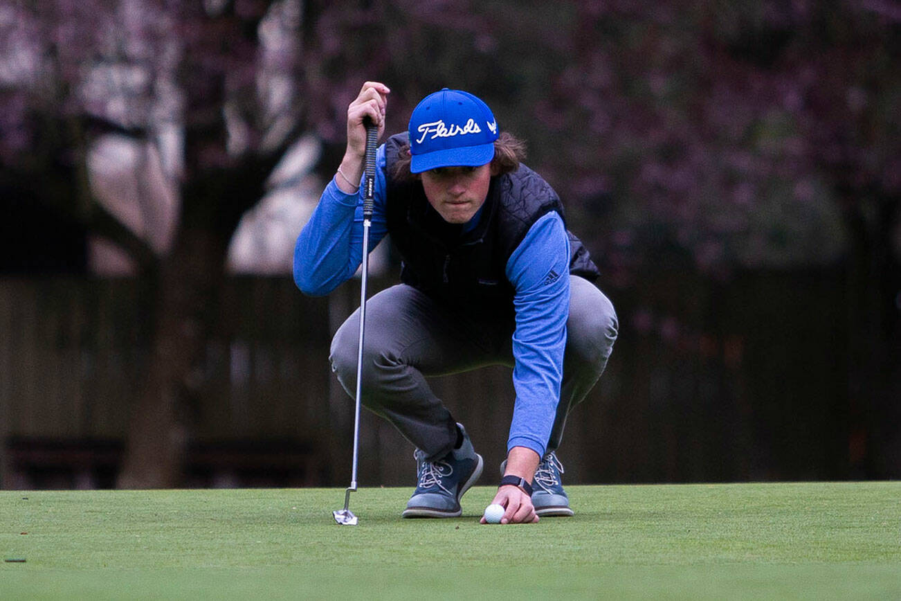 Shorewood’s Ben Borgida lines up his putt during the Tom Dolan Memorial Invitational at the Everett Golf & Country Club on Monday, April 11, 2022 in Everett, Washington. (Olivia Vanni / The Herald)