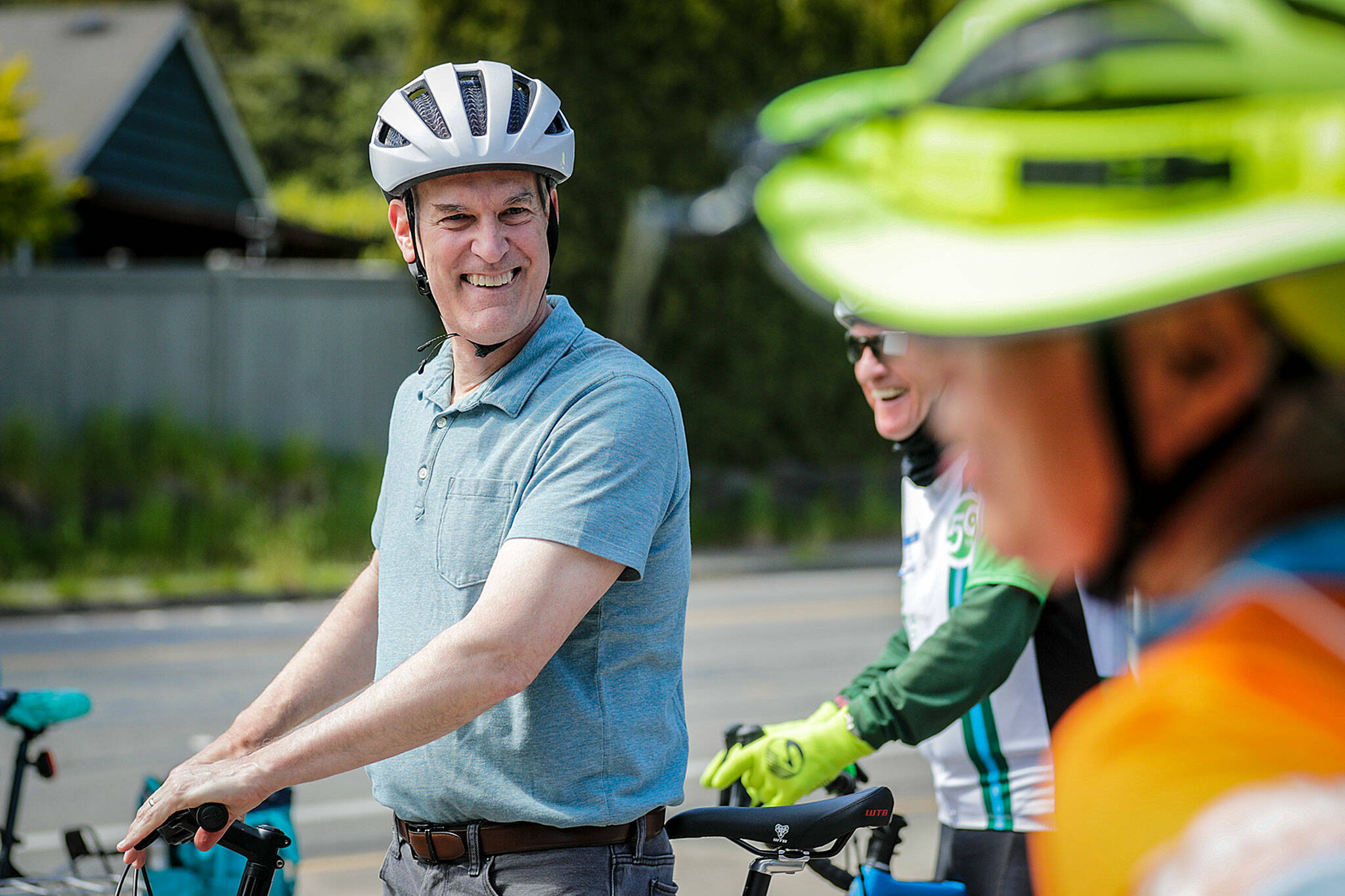 U.S. Rep. Rick Larsen shares a laugh during a bike tour of the Interurban Trail through Mountlake Terrace and Edmonds on Tuesday. (Kevin Clark / The Herald)