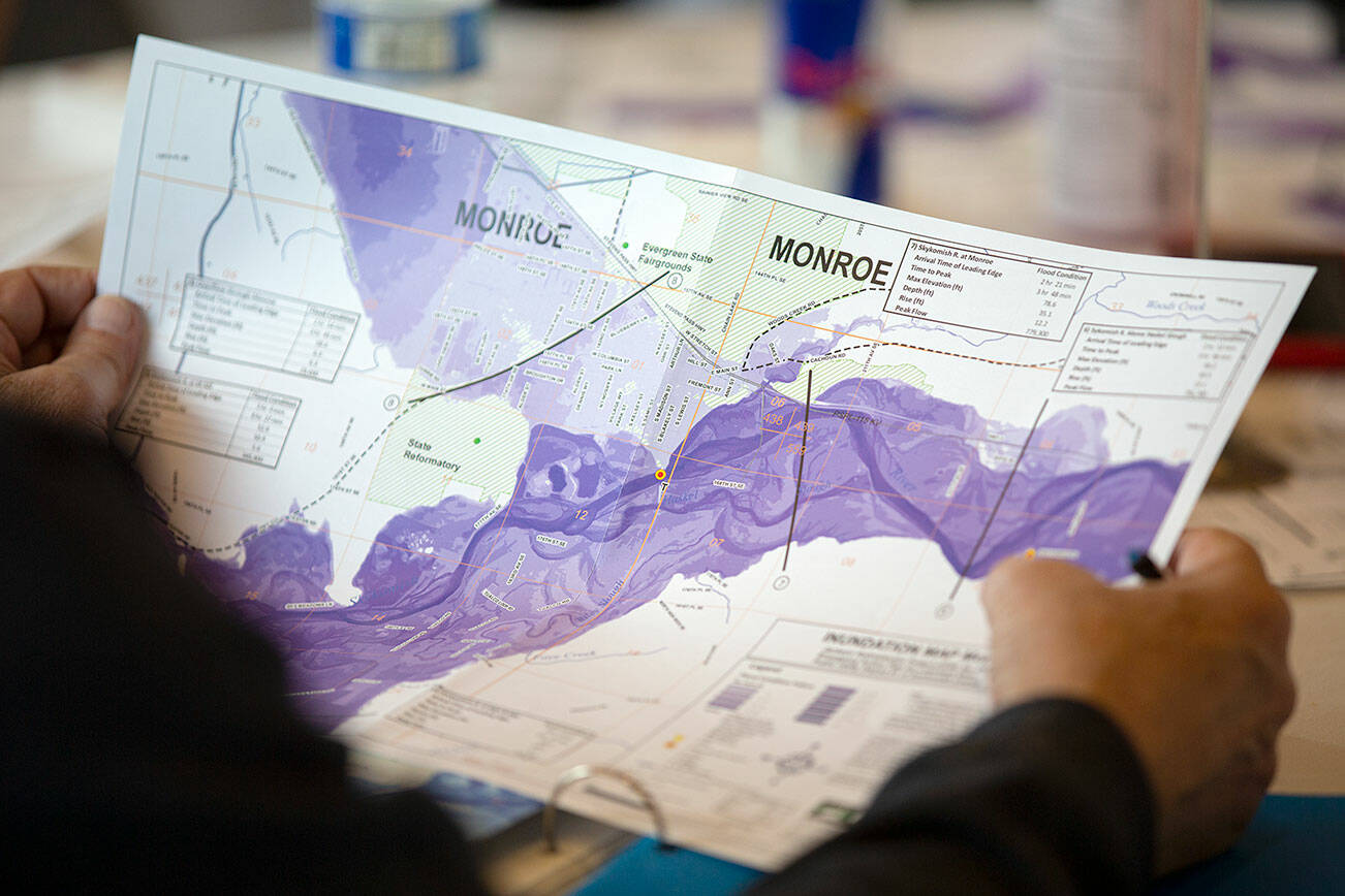 Ken Crossman, from Snohomish County Planning and Development, looks over a flood map of the Skykomish during a disaster simulation Wednesday, May 25, 2022, at Snohomish County Fire District 5 Station 51 in Sultan, Washington. (Ryan Berry / The Herald)