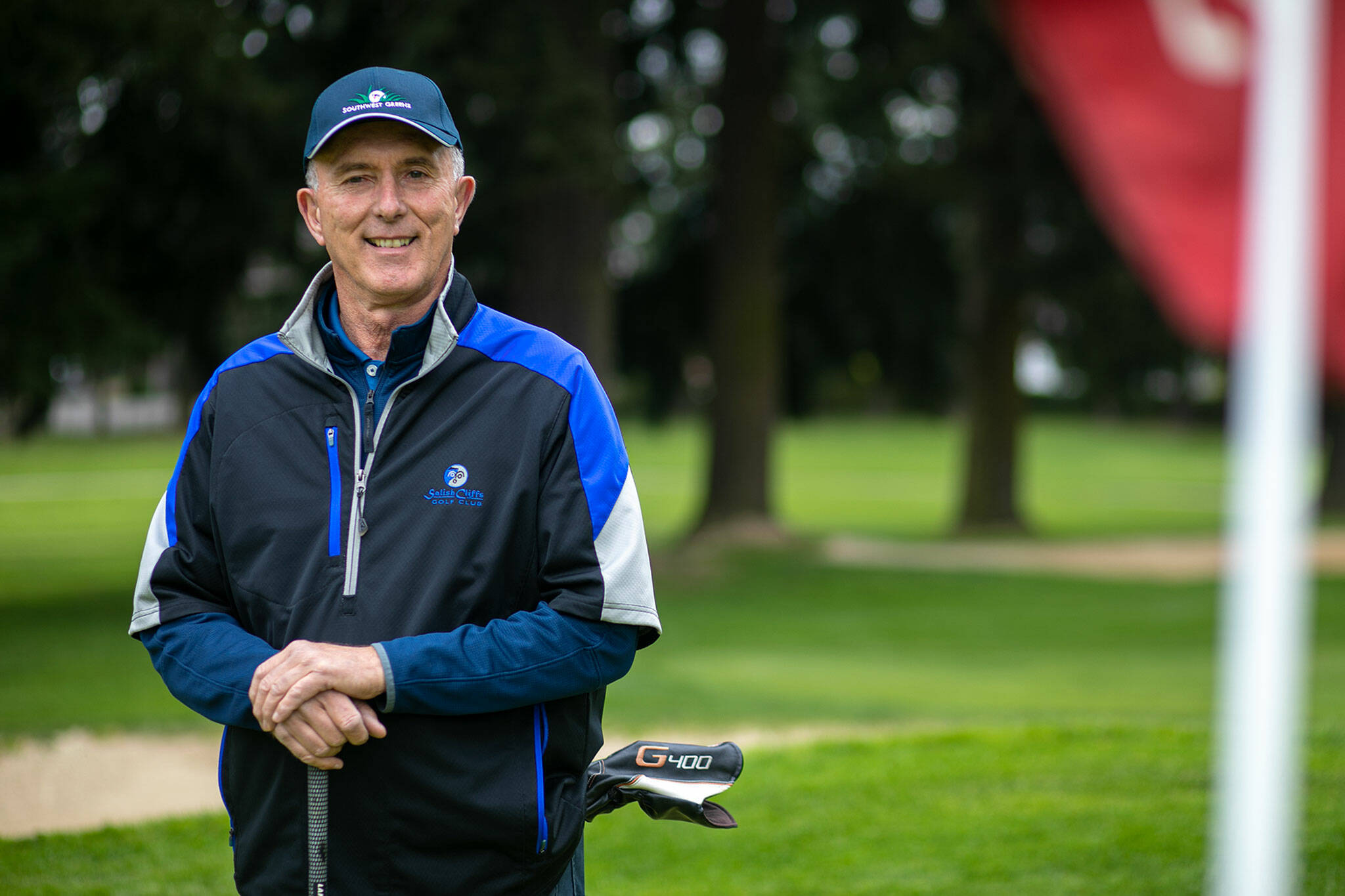 Duane Diede, who will be playing in his 50th Snohomish County Amateur Championship this month, stands on the 9th green at the Everett Golf and Country Club Friday, May 20, 2022, in Everett, Washington. He said he doesn’t expect anybody to ever break his record. (Ryan Berry / The Herald)