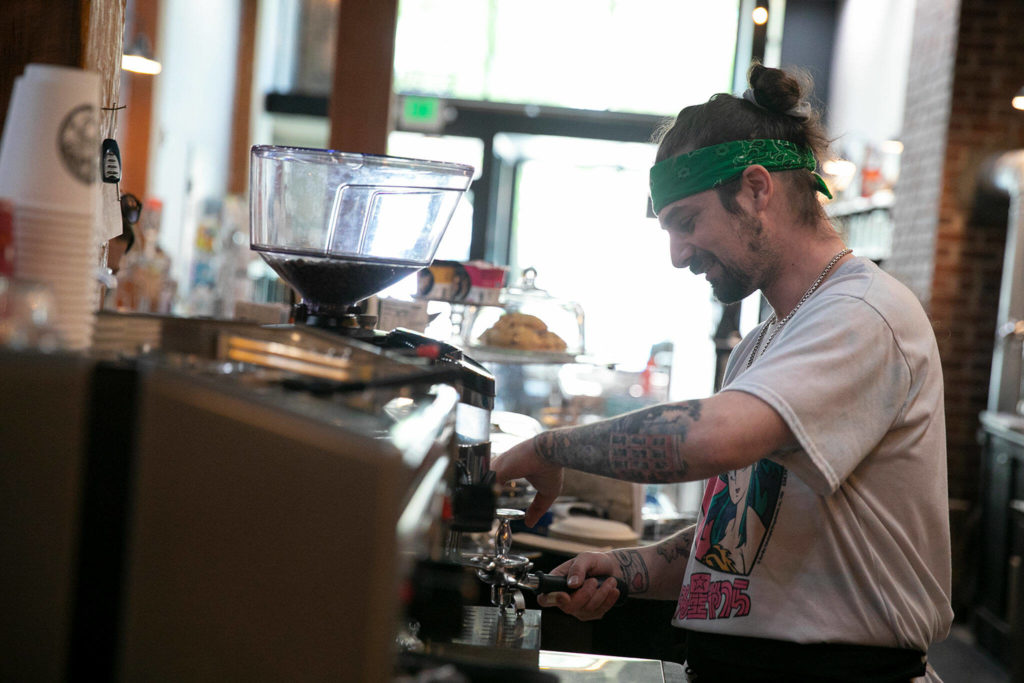 Dylan T. Riley prepares to pull a shot of espresso at Artisans Mercantile in Everett. (Ryan Berry / The Herald)
