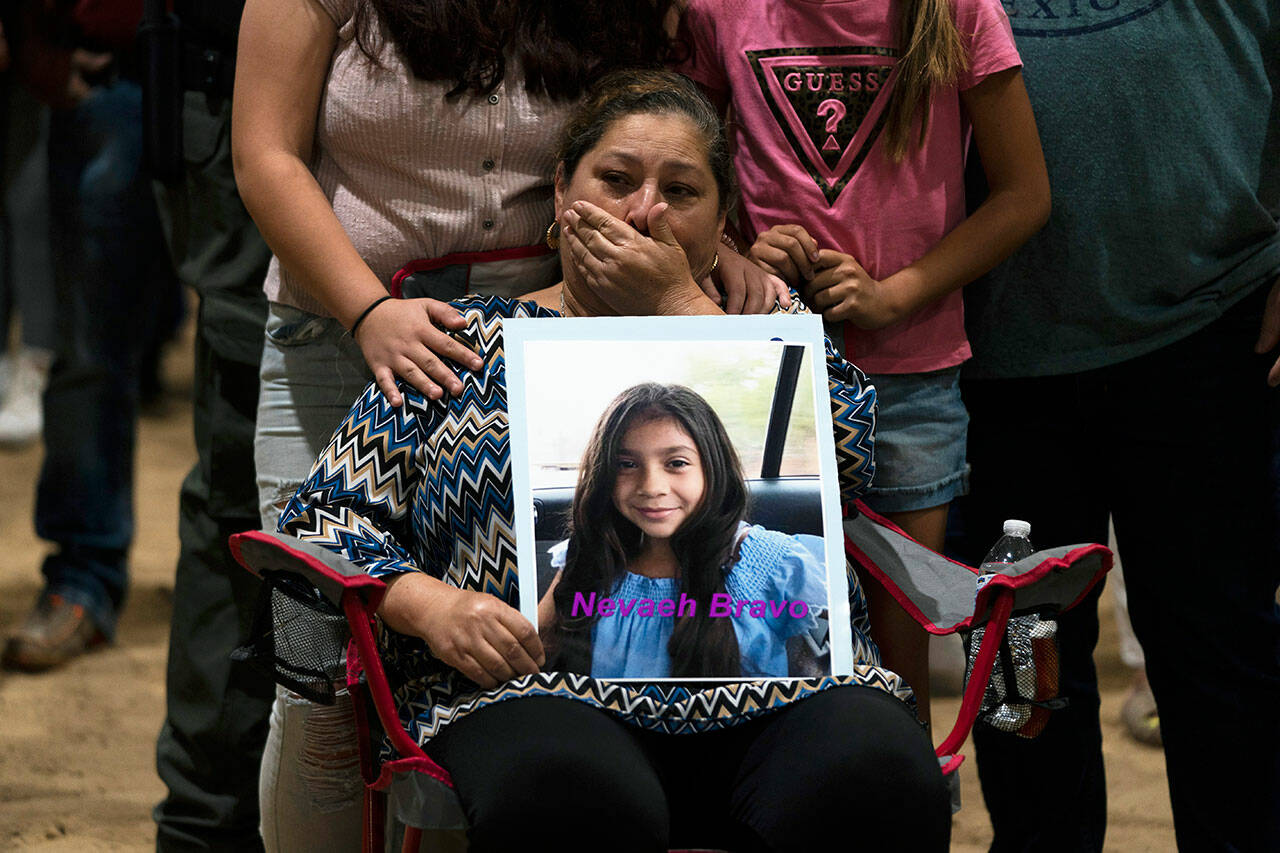 Esmeralda Bravo, 63, sheds tears while holding a photo of her granddaughter, Nevaeh Bravo, one of the Robb Elementary School shooting victims, during a prayer vigil in Uvalde, Texas, Wednesday. (Jae C. Hong / Associated Press)