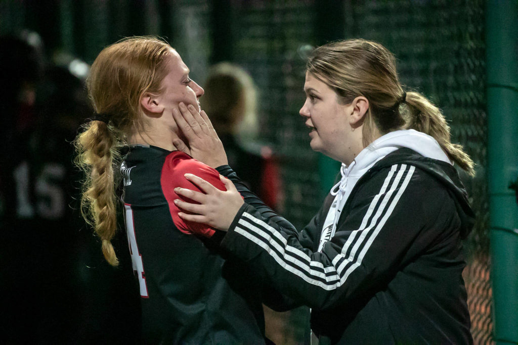 Snohomish’s Skyla Bristol is comforted by Emma Lande during the 3A quarter-final game against Roosevelt Friday evening in Lacey, Washington on May 27, 2022. The Panthers lost 14-13 in 8 innings. (Kevin Clark / The Herald)
