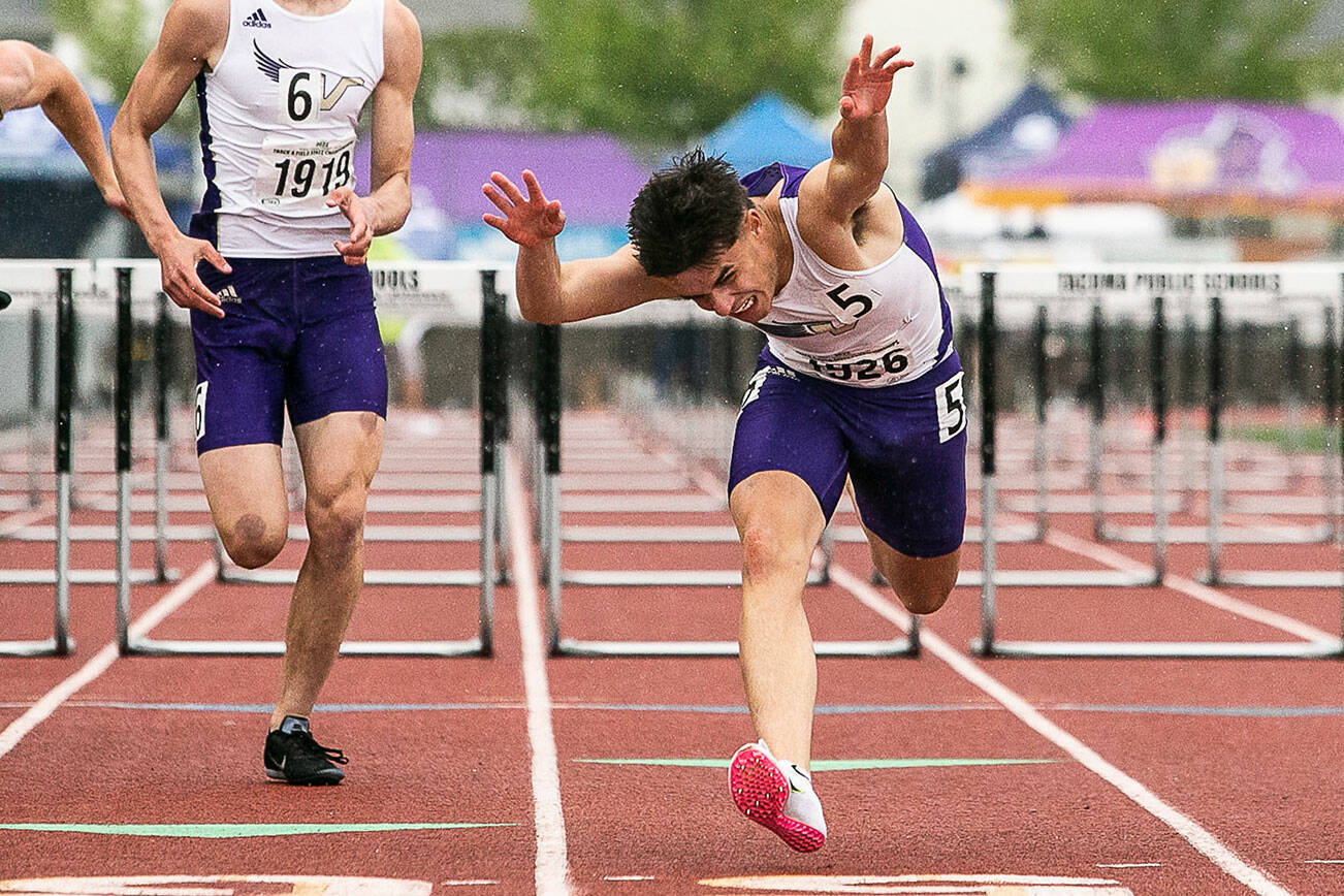 Lake Stevens’ Sean Martelles dives across the finish line at the end of the 4A 110 Meter Hurdles during the state track and field championships on Friday, May 27, 2022 in Tacoma, Washington. (Olivia Vanni / The Herald)