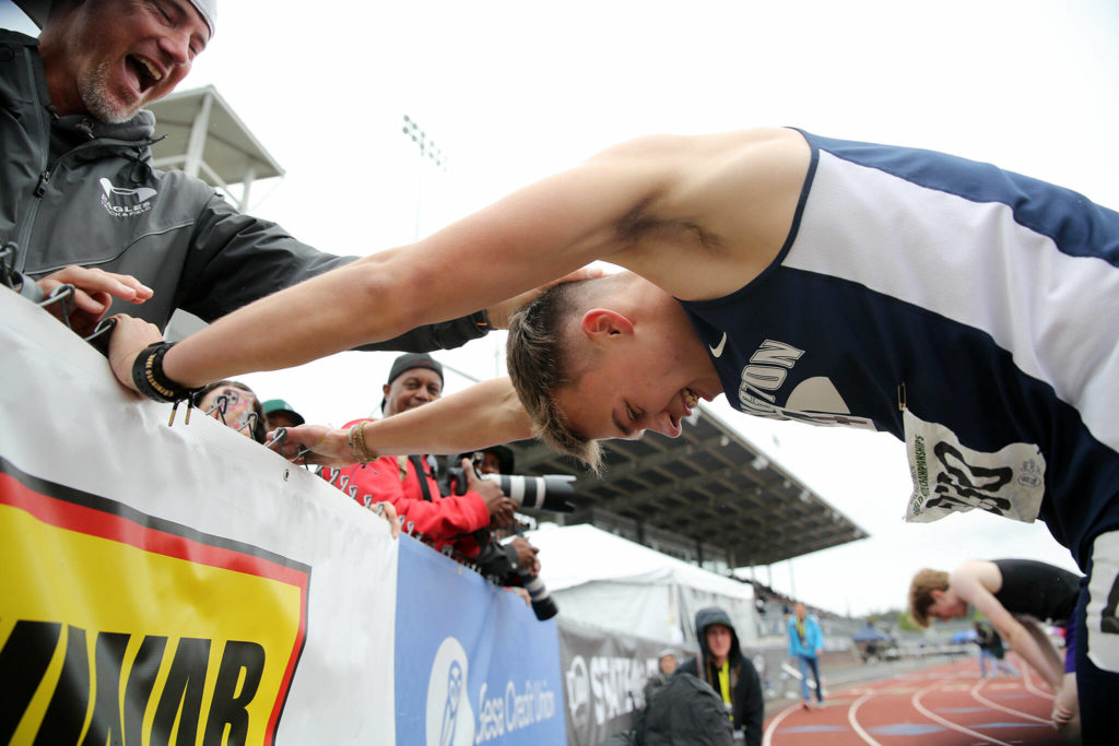 Arlington’s Parker Duskin is congratulated after winning the 3A boys 300 hurdles Saturday, May 28, 2022, at the 2022 WIAA State Track & Field Championships at Mount Tahoma High School in Tacoma, Washington. (Ryan Berry / The Herald)
