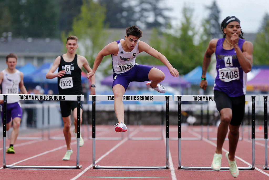 Lake Stevens’ Sean Martelles leaps over the final hurdle in the 4A boys 300 hurdles Saturday, May 28, 2022, at the 2022 WIAA State Track & Field Championships at Mount Tahoma High School in Tacoma, Washington. (Ryan Berry / The Herald)
