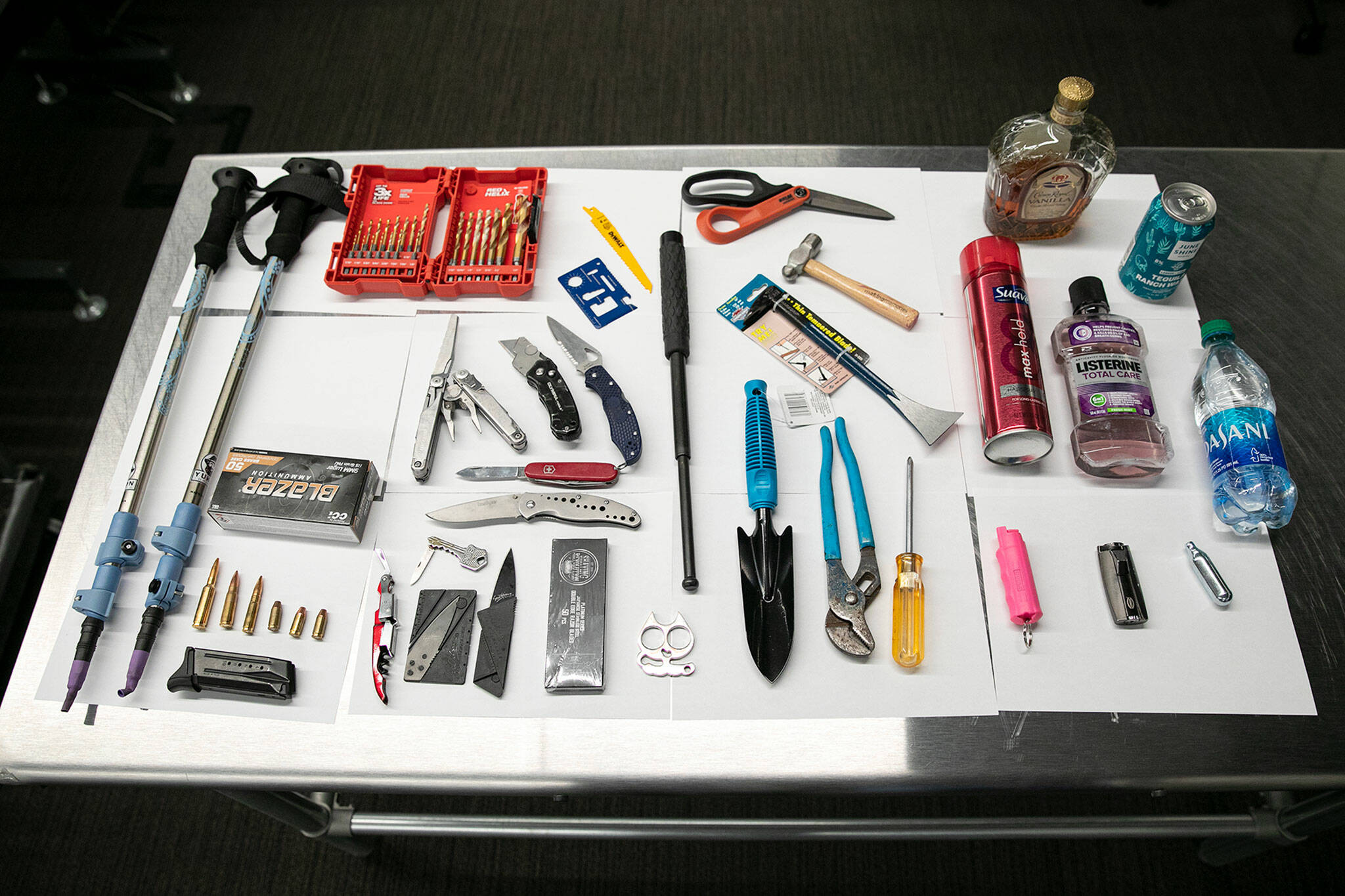 An array of items banned by the TSA are on display at Paine Field in Everett. All of these items had been collected within the past month. (Ryan Berry / The Herald)