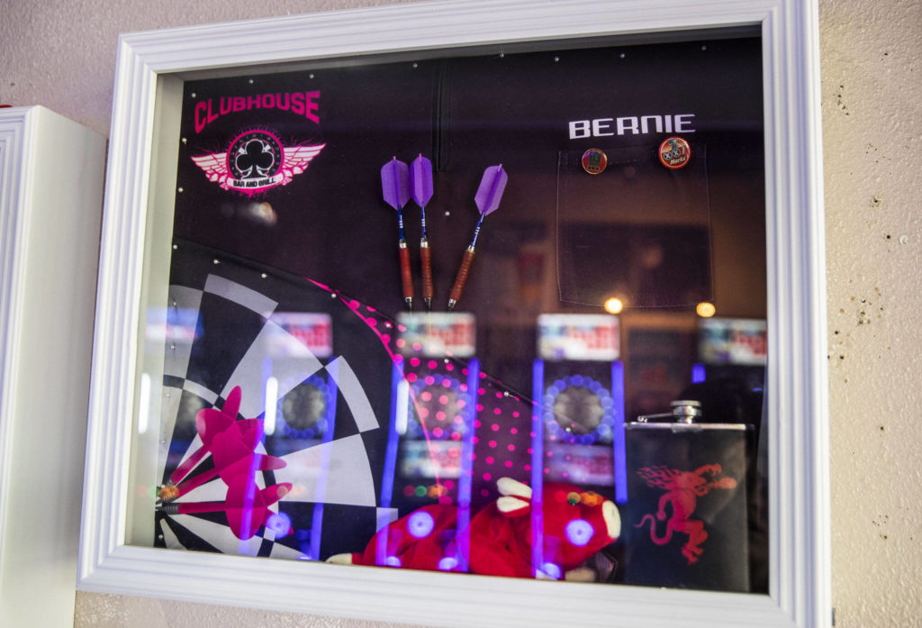 A small shadow box hangs on the wall inside the Clubhouse Bar and Grill in memory of Bernie Johnson. (Olivia Vanni / The Herald)
