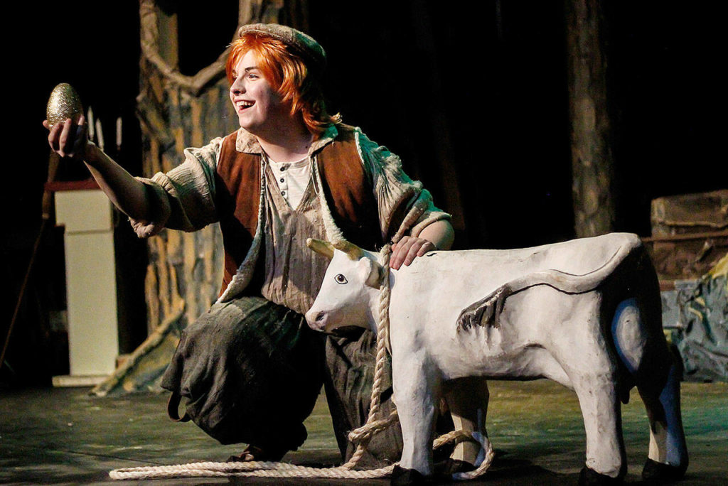 Jack (Dov Joel-Matthews) shows a magical golden egg to his bovine friend Milky White in Red Curtain’s production of “Into the Woods” in Marysville. (Layton Gaskins)
