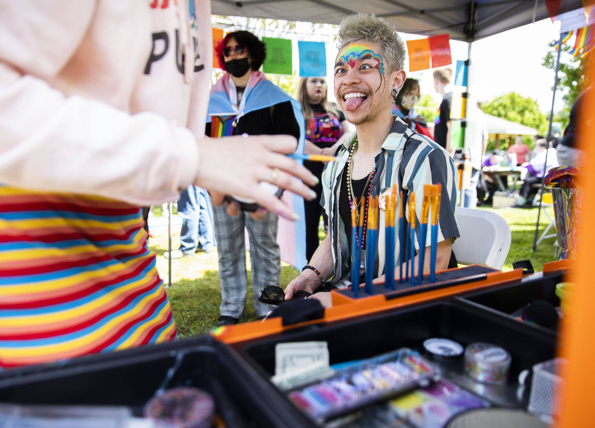 Michael Moaje makes a face while getting his makeup done during Arlington’s first-ever Pride celebration on Saturday. (Olivia Vanni / The Herald)