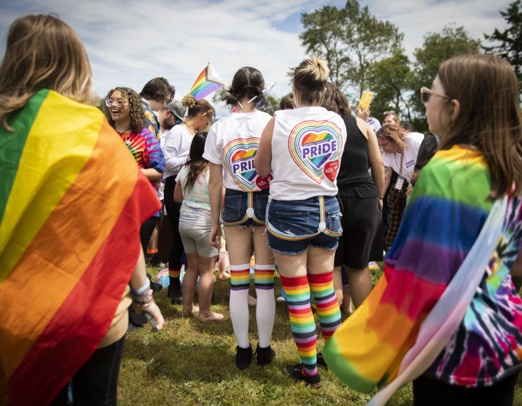 People gather for a color throw at Stanwood and Camano’s first-ever Pride celebration Saturday at Freedom Park. (Olivia Vanni / The Herald)
