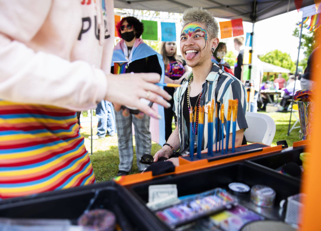 Michael Moaje makes a face while getting his makeup done during Arlington’s first-ever Pride celebration on Saturday. (Olivia Vanni / The Herald)
