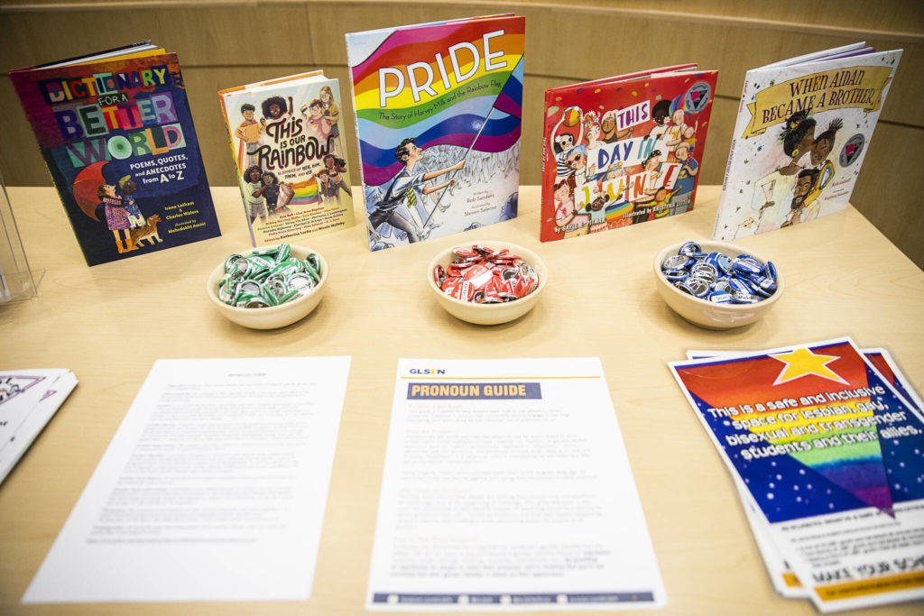 Literature and pamphlets at the Everett Public Schools district headquarters Pride month celebration Wednesday shows some of the material available at schools. (Olivia Vanni / The Herald)
